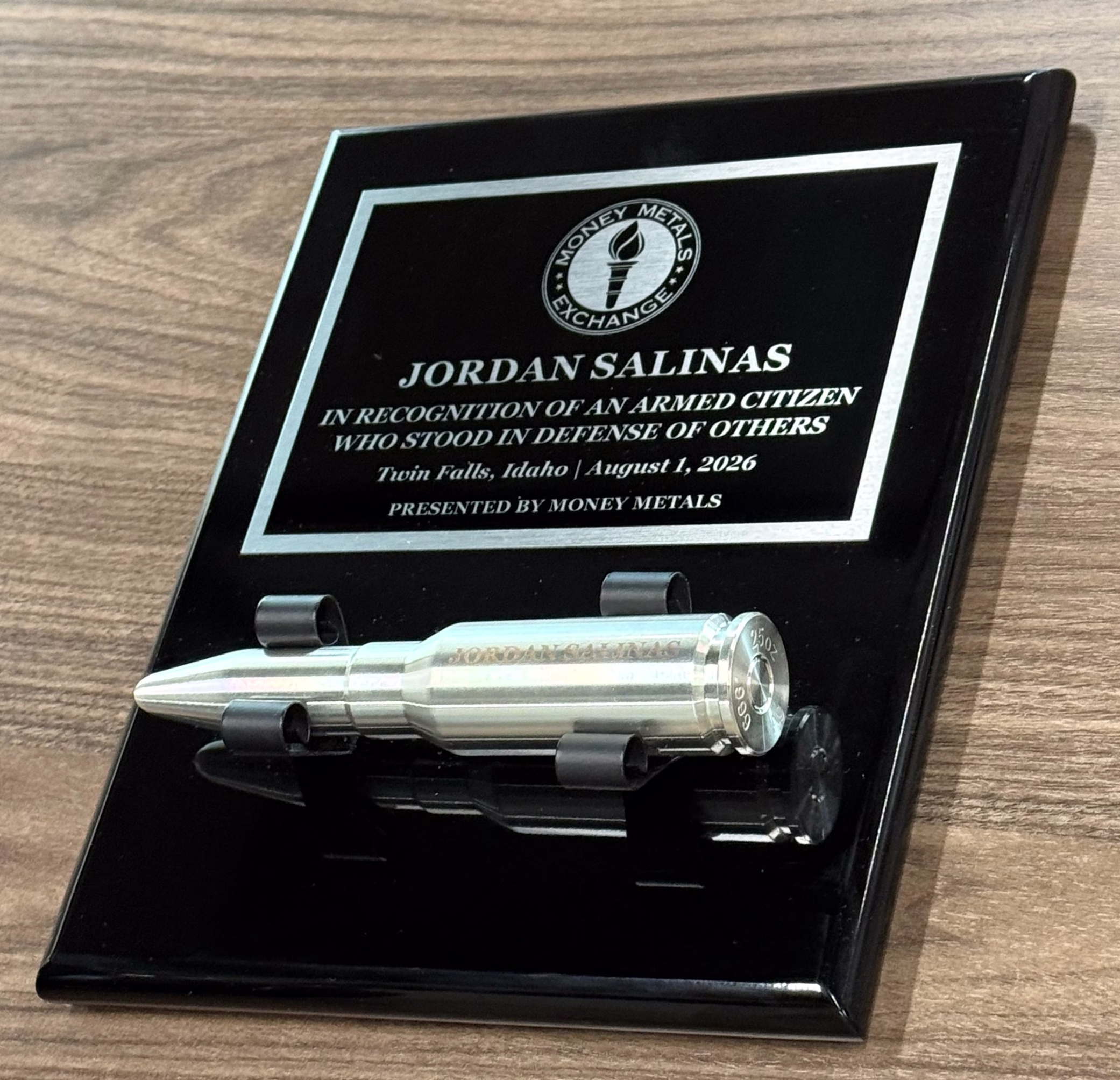 Twin Falls Hero Jordan Salinas Honored by Money Metals With Silver Bullet 2 Plaque that says JORDAN SALINAS, IN RECOGNITION OF AN ARMED CITIZEN WHO STOOD IN DEFENSE OF OTHERS, Twin Falls, Idaho | August 1, 2026, PRESENTED BY MONEY METALS