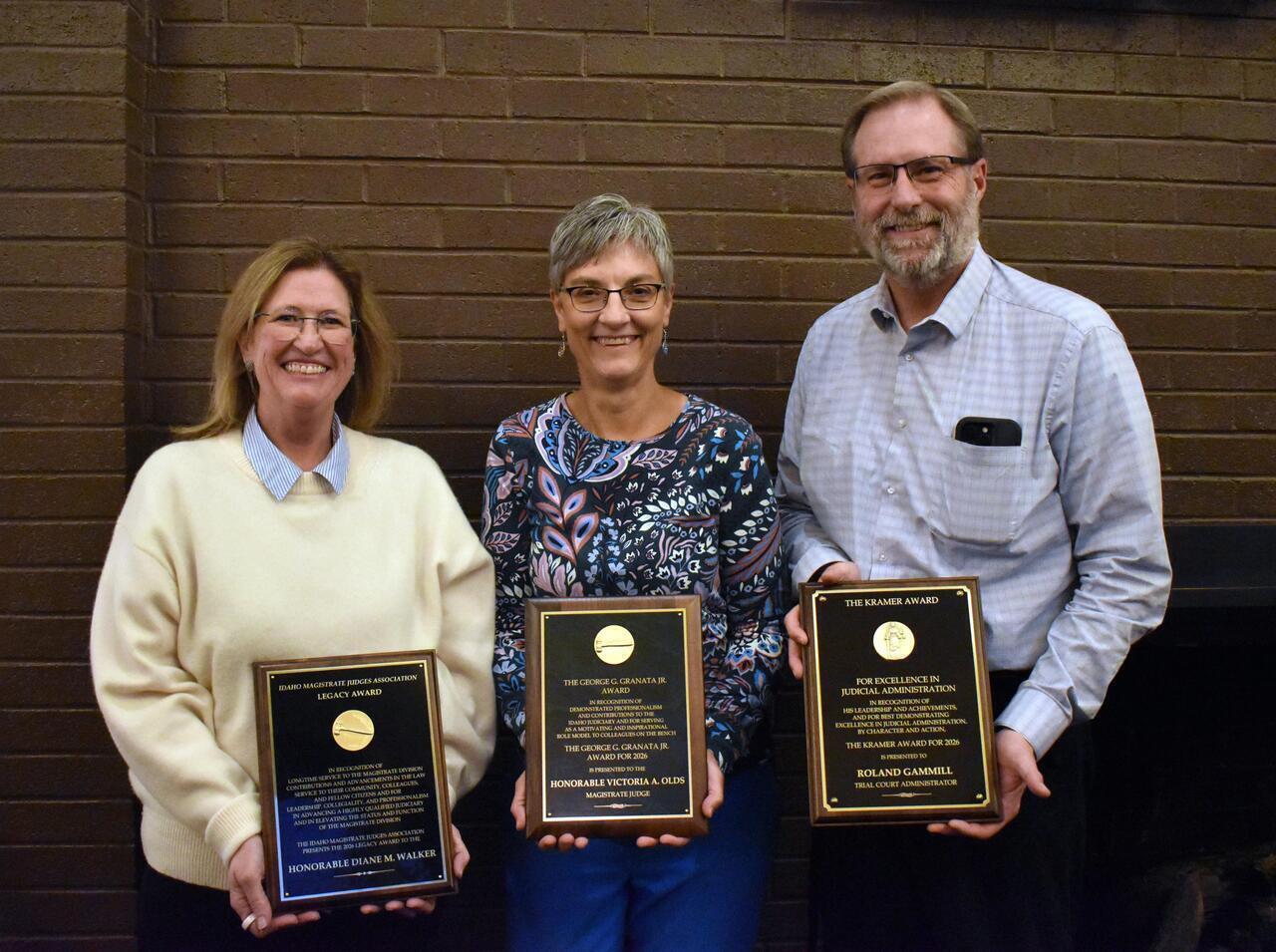 Judge Diane Walker, Judge Victoria Olds, and Trial Court Administrator Roland Gammill stand with their awards